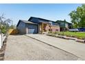 View of the home showing the driveway, garage and newly landscaped yard at 3491 Kassler Pl, Westminster, CO 80031