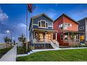 Charming blue two-story home with a red front door and covered porch, creating a welcoming curb appeal at 6309 N Hanover St, Denver, CO 80238