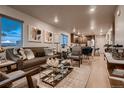 Open-concept living room with modern decor and hardwood floors, seamlessly connected to the dining area and kitchen at 6309 N Hanover St, Denver, CO 80238