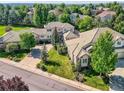 Aerial view of the neighborhood, showcasing the home's mature landscaping and privacy at 14064 E Whitaker Dr, Aurora, CO 80015