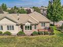 Aerial view showcases a backyard with a small deck and plenty of green space at 14064 E Whitaker Dr, Aurora, CO 80015