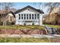 Charming brick home features a landscaped front yard and a welcoming walkway at 1282 S Sherman St, Denver, CO 80210