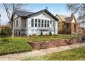 Charming brick home features a landscaped front yard and a welcoming walkway at 1282 S Sherman St, Denver, CO 80210