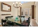 Elegant dining room with chandelier, large mirror, and spacious seating at 26 Royal Ann Dr, Greenwood Village, CO 80111