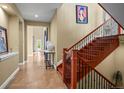 Inviting entryway with tiled floor, staircase, and decor at 26 Royal Ann Dr, Greenwood Village, CO 80111