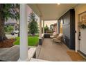 Relaxing front porch with white columns and comfortable seating, perfect for enjoying the neighborhood views at 2515 Zenobia St, Denver, CO 80212