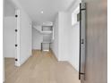 Bright entryway features light hardwood floors, white walls and ceilings, and a sleek open staircase at 300 S Franklin St, Denver, CO 80209