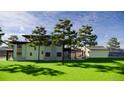Beautiful home exterior with a covered patio, mature trees, and lush green lawn at 300 S Franklin St, Denver, CO 80209