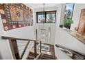 Inviting entryway features hardwood stairs, modern railing, and decorative lighting at 8453 S Scenic Dr, Morrison, CO 80465