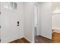 Bright entryway showcasing a white front door and beautiful hard wood floors at 24788 E 40Th Ave, Aurora, CO 80019