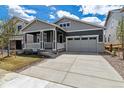 Charming single Gathering home featuring a cozy front porch and a two-car attached garage at 24788 E 40Th Ave, Aurora, CO 80019