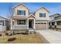 Charming two-story home featuring a covered porch, two-car garage and a combination of stone and siding exterior at 24788 E 40Th Ave, Aurora, CO 80019