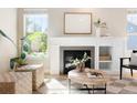 Bright living room features a fireplace, built-in shelving, and a cozy seating area at 2161 Willow Ct, Denver, CO 80238