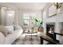 Comfortable living room with a fireplace, large windows, and stylish furnishings at 2161 Willow Ct, Denver, CO 80238