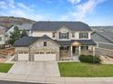 Stunning two-story home with a three-car garage, stone accents, and well-maintained landscaping at 2463 Tavern Way, Castle Rock, CO 80104