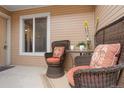 Cozy front porch with wicker chairs and an outdoor table perfect for relaxing and enjoying the scenery at 8112 Gray Ct # 394, Arvada, CO 80003