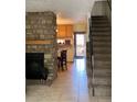 Inviting living room showcasing a stone fireplace, tiled floor and staircase access for a warm and cozy feel at 2285 S Jasper Way # A, Aurora, CO 80013