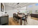 Open dining room with wood floors and a modern lighting fixture at 5411 Edenborn Way, Castle Rock, CO 80104