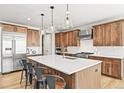 Gourmet kitchen with stainless steel appliances, a large island, and pendant lights at 5411 Edenborn Way, Castle Rock, CO 80104