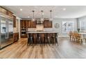 Modern kitchen boasts a large island, stainless steel appliances, and custom cabinets at 5411 Edenborn Way, Castle Rock, CO 80104