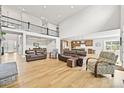 Spacious living room with high ceilings, wood floors, and an open floor plan at 5411 Edenborn Way, Castle Rock, CO 80104