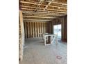 Unfinished kitchen area with exposed framing, wooden studs and a sliding door to the backyard at 664 Deer Park, Watkins, CO 80137