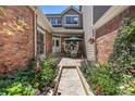 Charming patio with outdoor seating and lush garden featuring a variety of colorful plants at 9873 Greensview Cir, Lone Tree, CO 80124