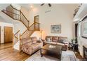 Spacious living room with hardwood floors, a staircase and comfortable seating, perfect for relaxation at 1521 Redtail Ct, Longmont, CO 80504