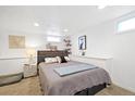 This basement bedroom features new carpet, shelving, neutral colors and ample lighting, creating a peaceful retreat at 4196 Chase St, Denver, CO 80212
