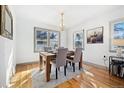 Charming dining room with modern chandelier, hardwood floors, and bright natural light at 4196 Chase St, Denver, CO 80212