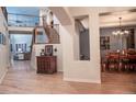 Elegant entryway with hardwood floors, staircase, and views to living and dining areas at 6588 S Sheridan Loop, Littleton, CO 80123
