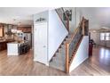 Stylish staircase with wrought-iron balusters and hardwood flooring at 6588 S Sheridan Loop, Littleton, CO 80123