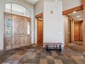 Inviting foyer boasting tile flooring, wooden accents, and plenty of natural light at 26886 Evergreen Springs Rd, Evergreen, CO 80439