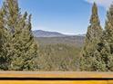 Picturesque mountain views visible from this treelined property, ideal for nature lovers at 26886 Evergreen Springs Rd, Evergreen, CO 80439