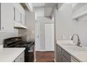 Clean kitchen, featuring gray cabinets and a stove at 1433 N Williams St # 801, Denver, CO 80218
