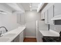 Well-lit kitchen with white counters, grey cabinets, and a modern faucet at 1433 N Williams St # 801, Denver, CO 80218