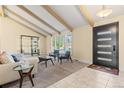 Inviting living room with exposed beams, large window, and seating area at 3970 S Syracuse Way, Denver, CO 80237