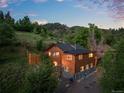Charming log home with lush greenery and fenced yard at 2874 Se Grapevine Rd, Idledale, CO 80453
