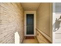 Home entryway with stone veneer walls, modern door, and smooth railing at 4644 Hatcher Dr, Brighton, CO 80601