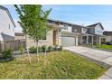 Two-story home featuring a green lawn, stone veneer, and two-car garage at 4644 Hatcher Dr, Brighton, CO 80601