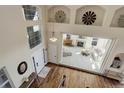 Open foyer with wood floors, high ceilings, and a view into the living room with a fireplace at 6078 Bridle Path Ln, Parker, CO 80134