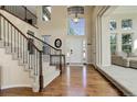 Bright foyer with hardwood floors, a staircase, and a view into the living area at 6078 Bridle Path Ln, Parker, CO 80134
