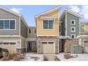 Charming exterior of a modern home featuring a stone facade, attached garage, and well-kept front yard at 9719 Albion Ln, Thornton, CO 80229