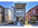 Modern two-story home with a covered porch and balcony, showcasing contemporary design and curb appeal at 8728 Hotchkiss St, Littleton, CO 80125