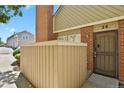 Inviting brick townhouse entrance with a cozy, sheltered front patio area at 3300 W Florida Ave # 26, Denver, CO 80219