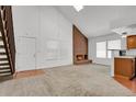 Inviting living room with vaulted ceilings, brick fireplace, and abundant natural light at 3300 W Florida Ave # 26, Denver, CO 80219