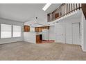Bright, open-concept living space featuring skylights, neutral carpet, and an open kitchen at 3300 W Florida Ave # 26, Denver, CO 80219