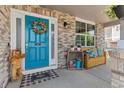 Inviting front porch with a bench, a wreath on the front door, and a decorative bear, offering a warm welcome at 11921 S Black Horn Cir, Parker, CO 80134