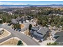 Aerial view of a neighborhood showcasing mountain views and mature trees at 7515 Pineridge Trl, Castle Pines, CO 80108