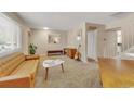 Bright living room with a leather couch, neutral walls, and staircase to the upper level at 387 Upham St, Lakewood, CO 80226